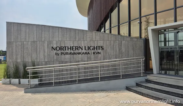 A close-up of the elegant stone-cladded entrance wall with NORTHERN LIGHTS by PURAVANKARA